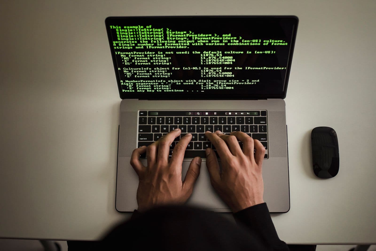 Developer working with code on a laptop